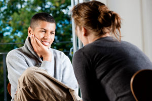 Young boy talking to therapist