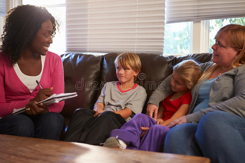 therapist talking to mother and two children