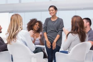 Women presenting in front of peers
